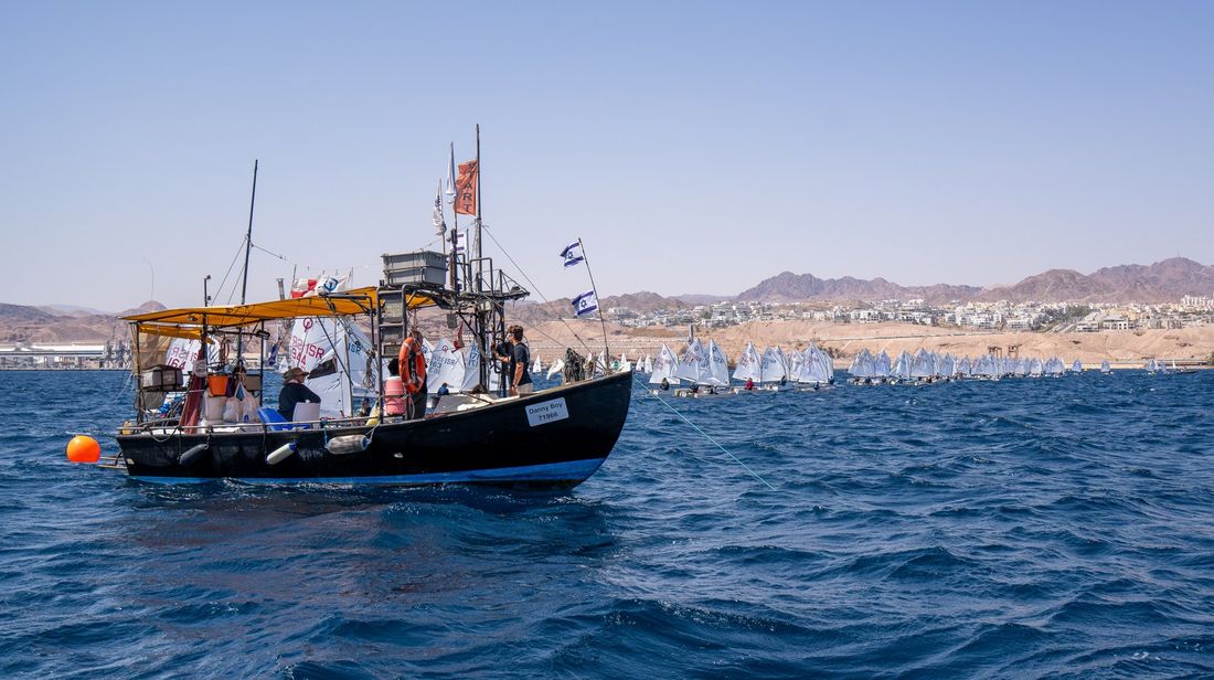 Committee boat on the start line of an Optimist regatta in Eilat